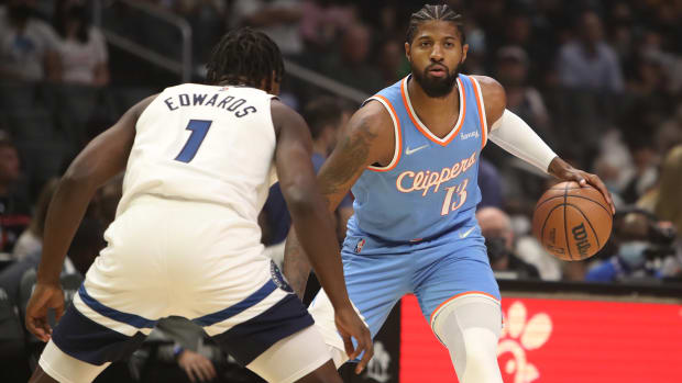 Los Angeles Clippers forward Paul George dribbles the ball against Minnesota Timberwolves guard Anthony Edwards.